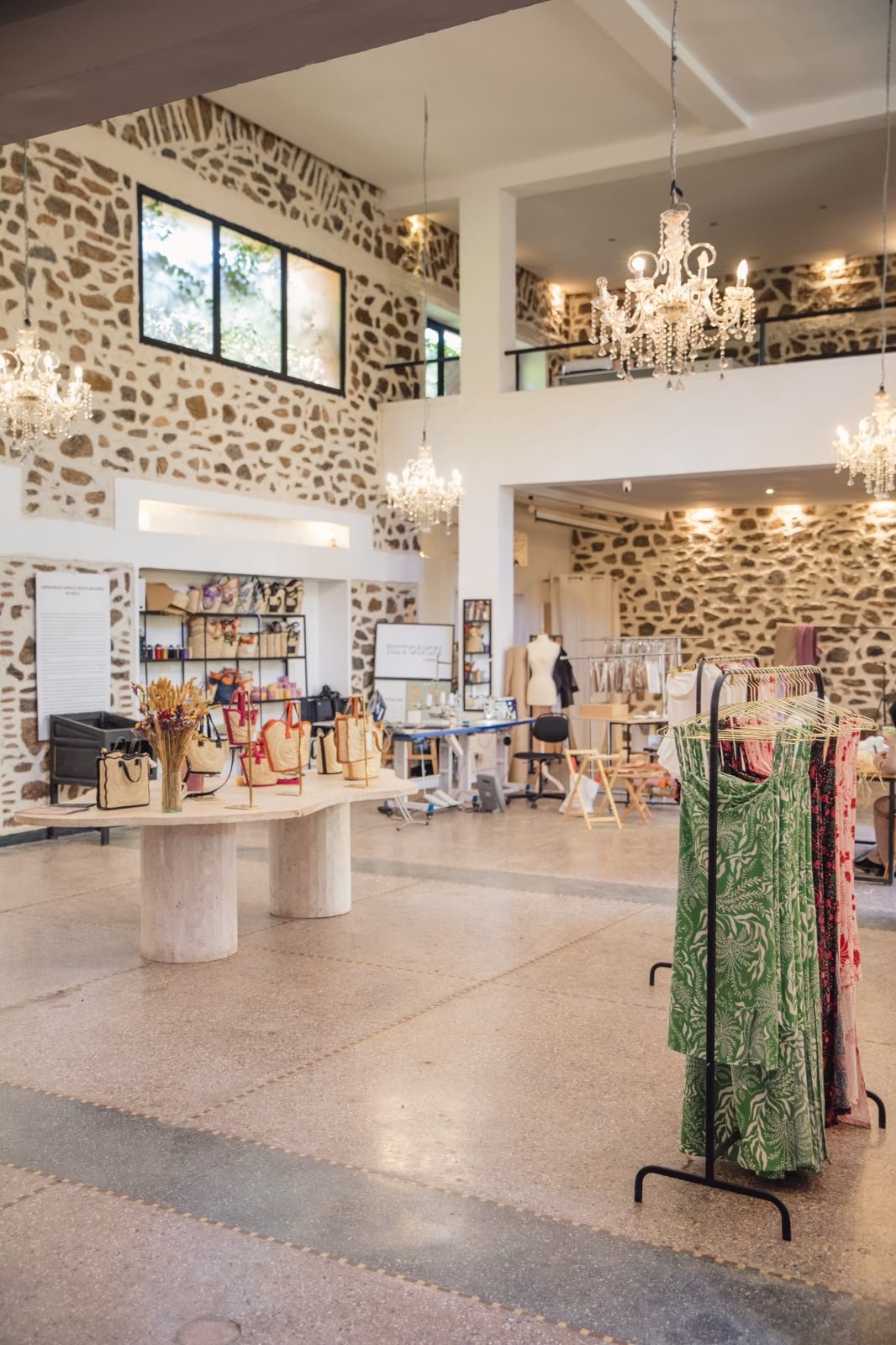 Le studio YZA à Guéliz — intérieur en pierre, chandeliers, présentoirs de paniers et portants